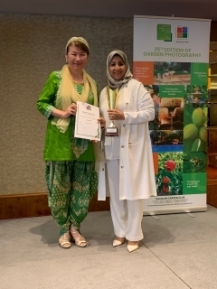 Ambassador Okai presented a trophy to Ms. Nadia